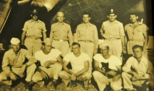 Ted Diamond (top row, second from right) pictured with members of WWII crew in front of bomber.